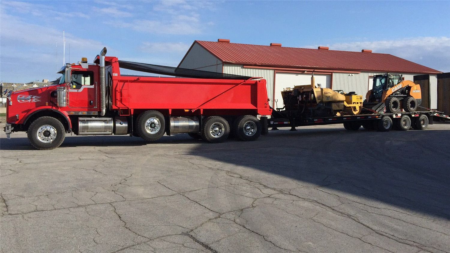 Heavy-duty construction truck transporting landscaping equipment and materials for a Toronto exterior renovation project. Professional logistics and machinery ensure efficient site preparation and smooth progress for large landscaping and driveway installations.