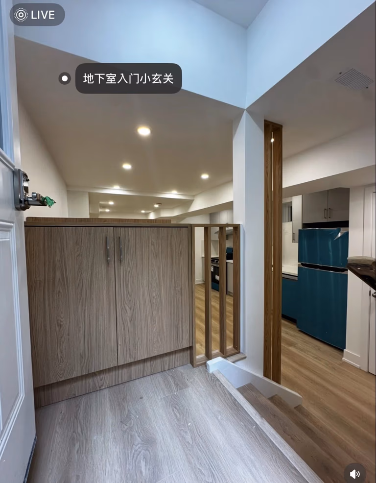 This basement entrance features a dedicated entryway in a Toronto legal 3-unit conversion project. The design creates a clear transition between outdoor access and the interior living space, enhancing privacy and functionality for rental use.