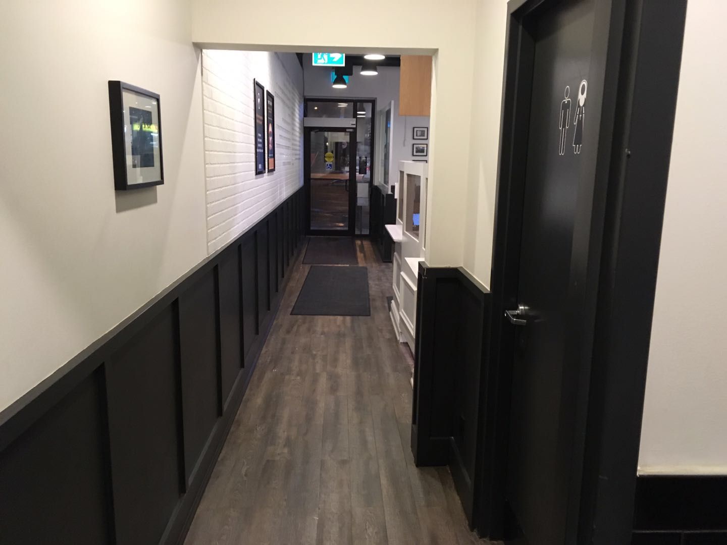This Toronto spa renovation features a clean and well-organized corridor with durable flooring, wall panel detailing, and efficient space planning. The design enhances traffic flow while maintaining a modern and professional commercial interior.