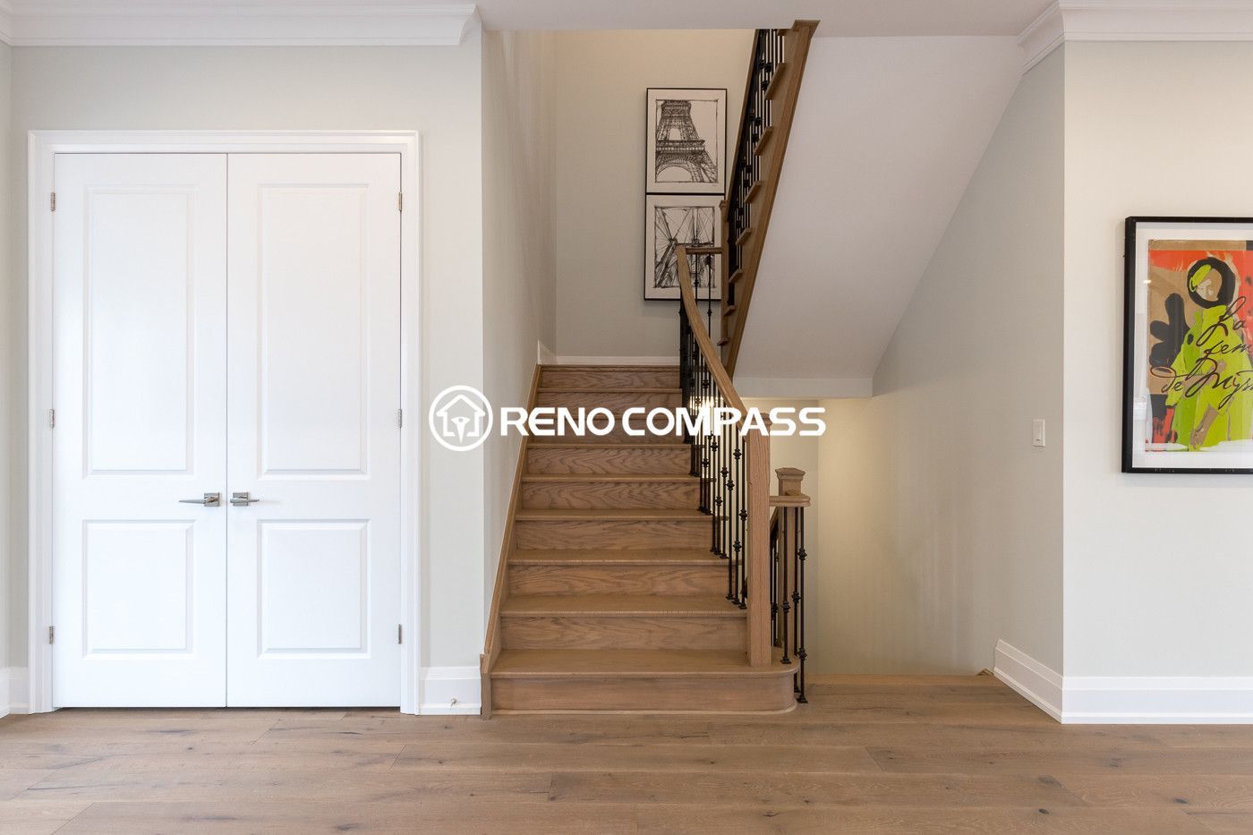 This image shows part of a Newmarket home flooring renovation project in the Toronto area, featuring professionally installed engineered wood flooring and a modern staircase design. The natural wood flooring creates a warm and elegant interior while maintaining excellent durability and stability. Engineered wood flooring is constructed with multiple cross-layered wood boards, which helps reduce expansion and warping caused by humidity changes.

The clean installation and seamless transition between the flooring and staircase enhance the overall visual flow of the home interior. This renovation project was completed by Reno Compass Inc., a Toronto renovation company specializing in flooring installation and interior renovation projects.