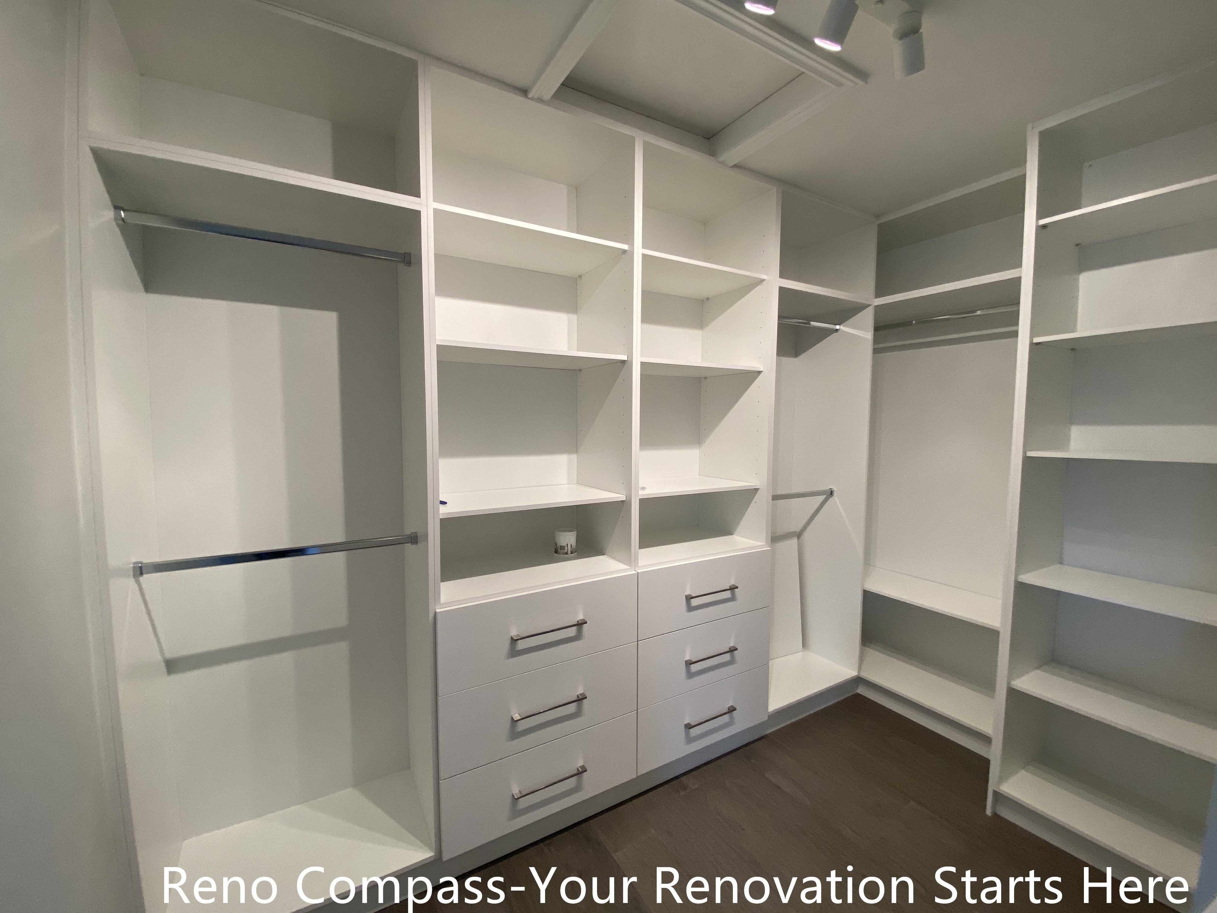 Custom walk-in closet featured in an Oakville interior renovation, showcasing built-in shelving, hanging rods, and integrated drawer storage for optimal organization. The clean white cabinetry and functional layout provide a modern storage solution designed and completed by a professional Toronto renovation company.