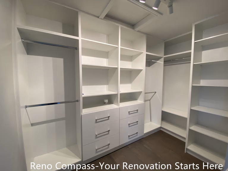 Custom walk-in closet featured in an Oakville interior renovation, showcasing built-in shelving, hanging rods, and integrated drawer storage for optimal organization. The clean white cabinetry and functional layout provide a modern storage solution designed and completed by a professional Toronto renovation company.