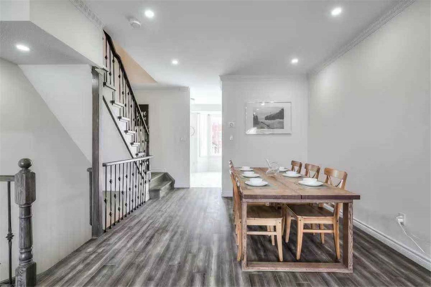 This Thornhill interior renovation features a bright open-concept dining and living area with new wood-style flooring, smooth wall painting, and modern recessed pot lighting. The upgraded staircase with iron railings and refreshed finishes enhance the home’s spacious layout and contemporary style. Completed by a professional Toronto renovation team, this project delivers a clean, functional interior designed for comfortable modern family living.