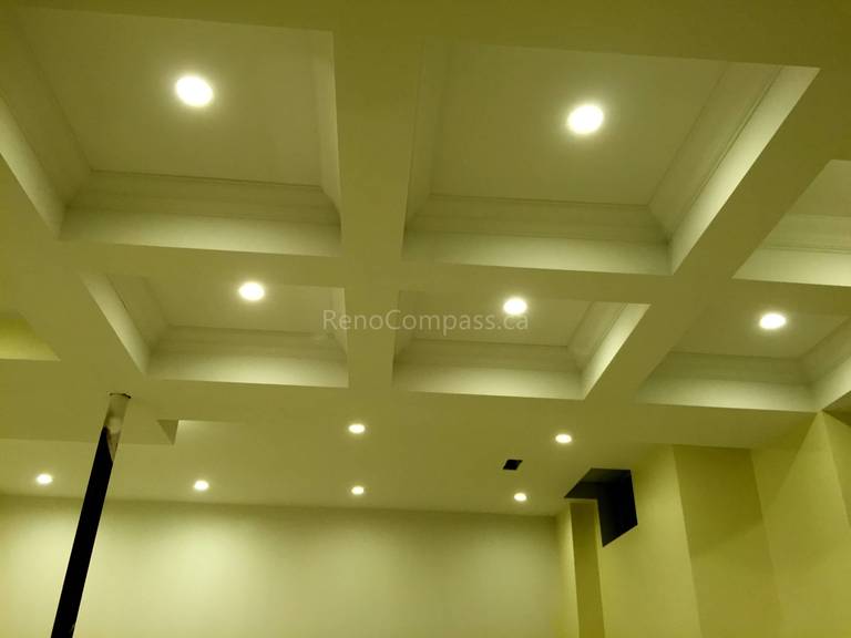 This Toronto interior renovation by Reno Compass features a custom coffered ceiling design paired with recessed LED pot lights for a refined and modern finish. The structured ceiling layout enhances architectural depth while improving overall lighting distribution throughout the space. With precise craftsmanship and clean detailing, this ceiling upgrade adds elegance, brightness, and long-term value to the home’s interior design.