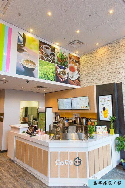 Bubble tea shop commercial renovation in Toronto featuring a bright service counter, decorative wall graphics, digital menu boards, and efficient drink preparation area. This modern retail renovation creates a clean and welcoming bubble tea store environment while optimizing workflow for staff and customer service. A professional Toronto bubble tea shop renovation project completed by a Toronto renovation company.