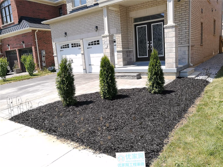 This Stouffville landscaping renovation features a newly installed interlock walkway and refreshed front yard garden bed with evergreen planting and decorative mulch. The curved hardscape design creates a smooth transition from driveway to porch while improving curb appeal and outdoor usability. Completed as part of a professional Toronto landscaping renovation project, the upgrade enhances both the visual balance and long-term durability of this modern residential front entrance.
