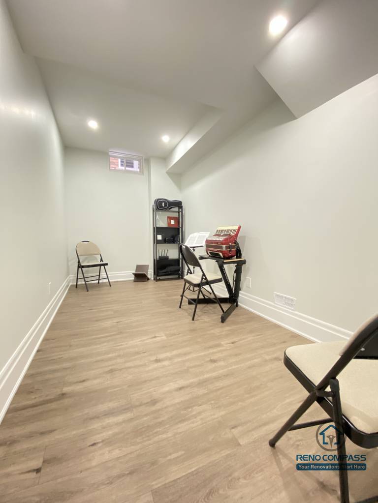 This Oakville basement renovation includes a simple, quiet room designed for flexible use such as meetings, lessons, practice, or temporary workspace needs. The room features continuous wood flooring, recessed ceiling lighting, and light-colored walls that enhance brightness and openness despite the compact footprint. A clean layout allows easy reconfiguration based on changing needs. As a professional Toronto renovation company, Reno Compass designs basement rooms that maximize usability, comfort, and adaptability, making every square foot functional and future-ready.