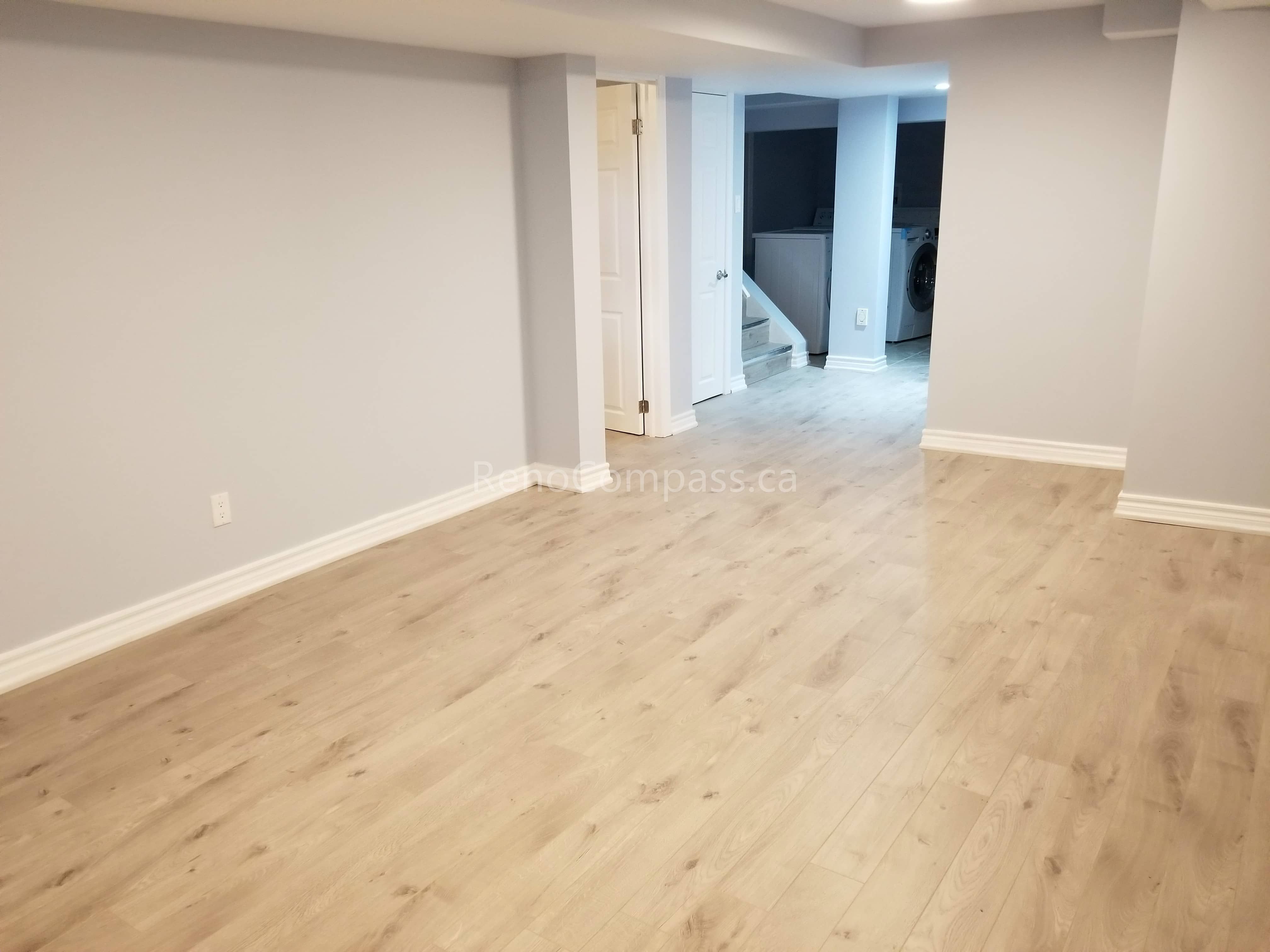 This Mississauga basement renovation features a clean, modern open-concept layout with newly installed light-tone flooring and fresh neutral wall finishes. The upgraded space offers improved brightness, comfort, and functionality, creating a versatile area suitable for family living, entertainment, or rental potential.

Completed by Reno Compass Inc., this basement upgrade highlights quality flooring installation, refined finishing details, and professional craftsmanship to enhance both usability and property value.
