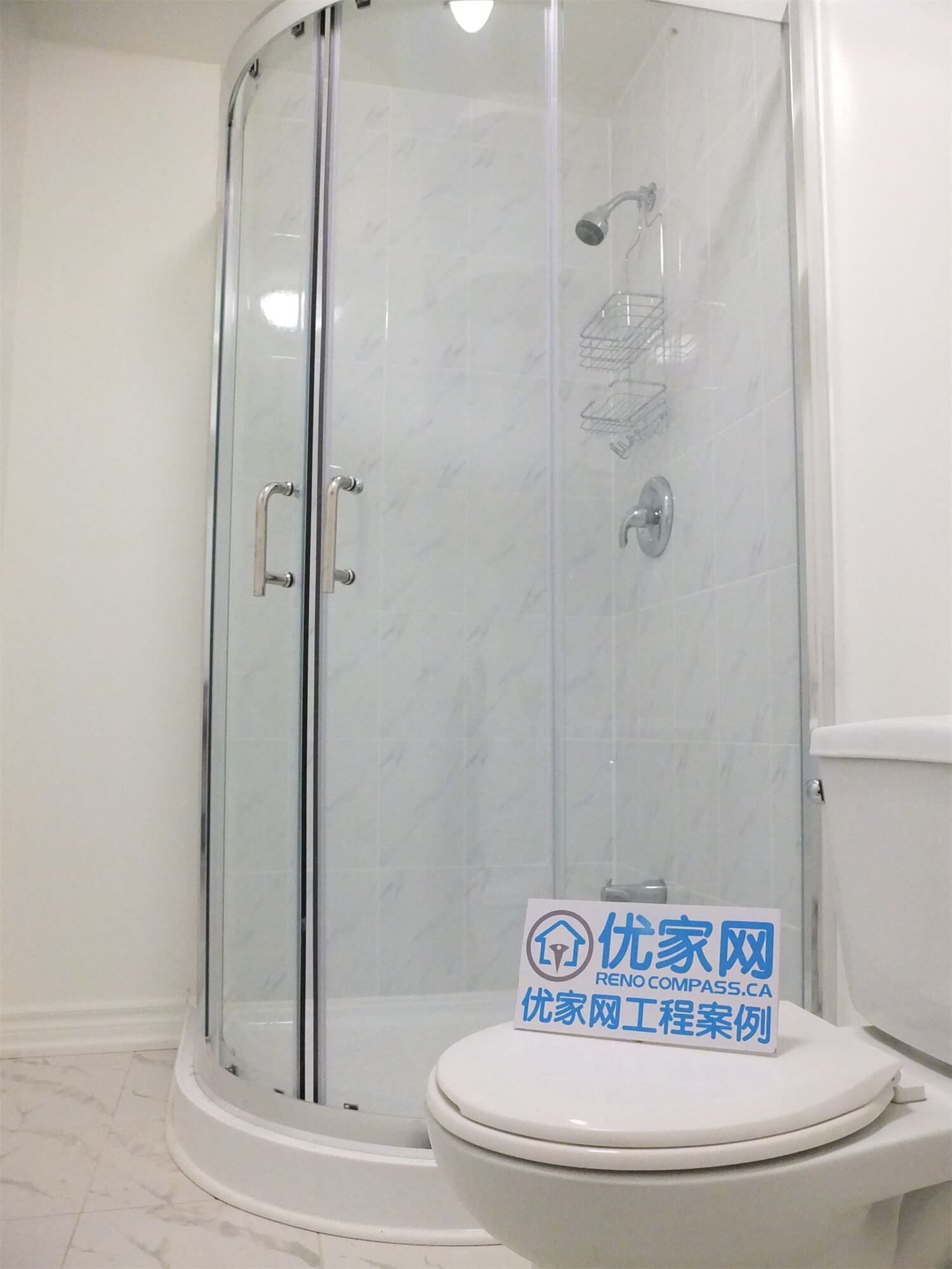 This Markham basement renovation includes a compact bathroom upgrade featuring a modern corner glass shower enclosure. The curved glass doors, marble-style shower wall panels, and clean white fixtures create a bright and functional shower space. The efficient layout and waterproof finishing make the basement bathroom both practical and visually appealing.