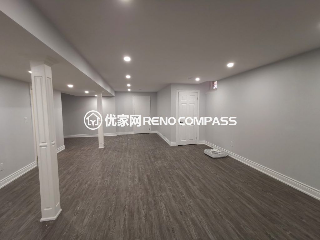 Richmond Hill basement renovation featuring a spacious open-concept layout, modern waterproof flooring, structural support columns, and recessed pot light installation. The newly finished basement offers bright lighting and flexible living space, completed by a professional Toronto renovation company.
