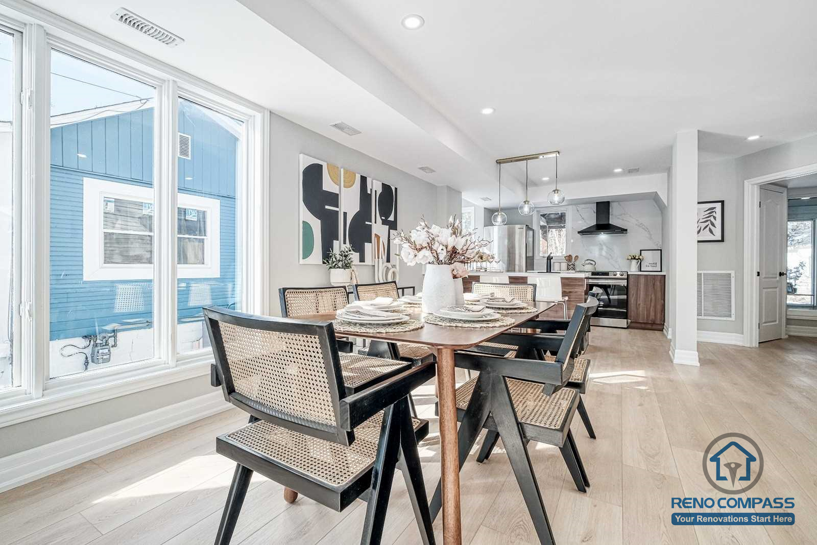 This Georgian interior renovation showcases an open dining area with large windows, natural light, and seamless connection to the kitchen. Light wood flooring and clean finishes create a bright, timeless space completed by a Toronto renovation company.