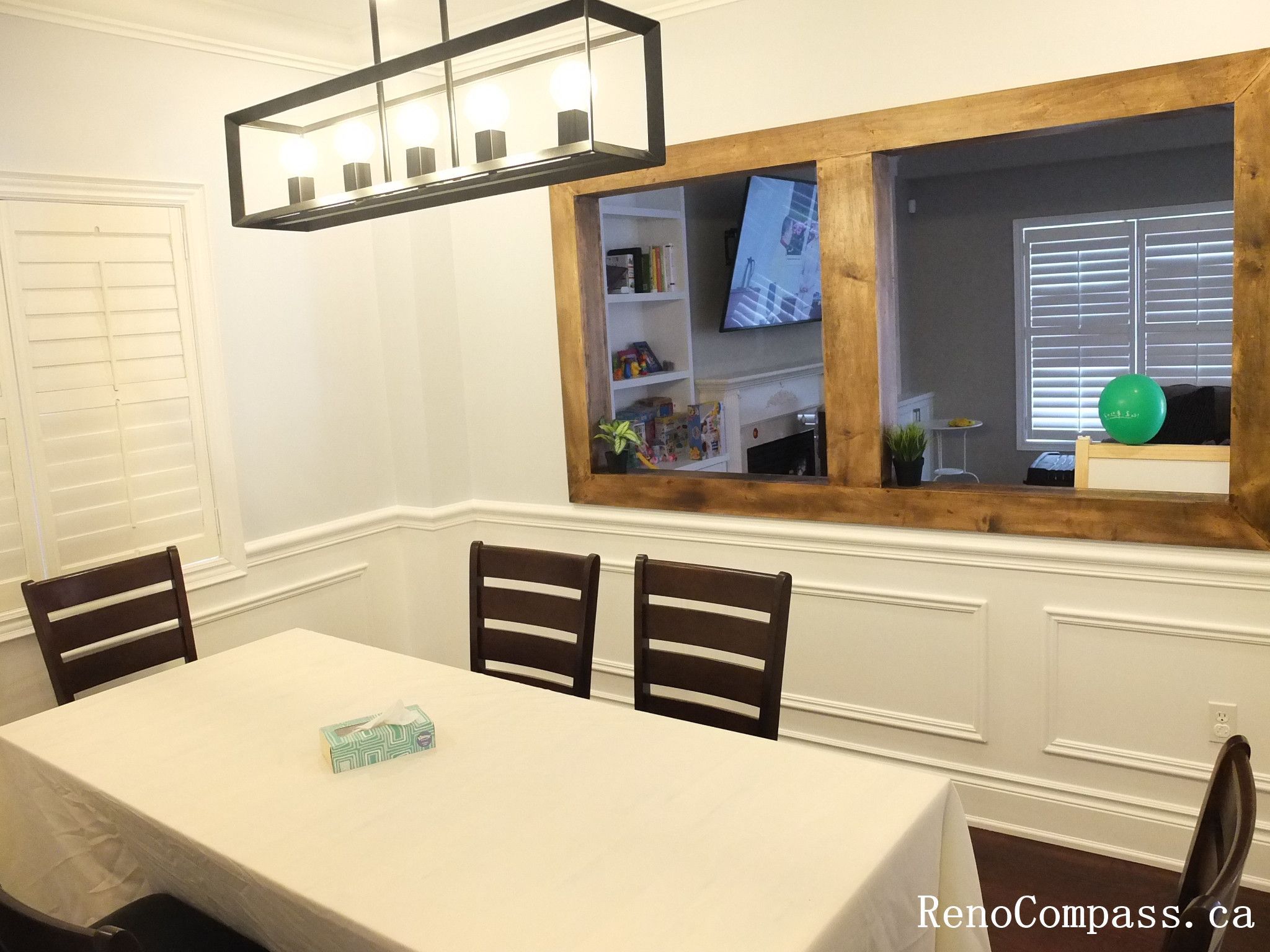 Formal dining room renovation in Newmarket featuring custom wall panel molding, recessed pot lights, modern pendant lighting, hardwood flooring, and a clean symmetrical layout. Completed by a trusted Toronto Renovation Company, this interior upgrade enhances elegance and everyday functionality.
