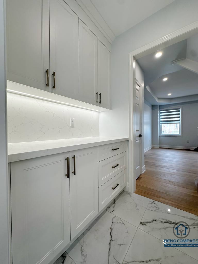 Open-concept main floor featuring a custom staircase with wood treads and black metal railing, seamlessly connecting the living area and upper level while enhancing natural light and spatial flow.