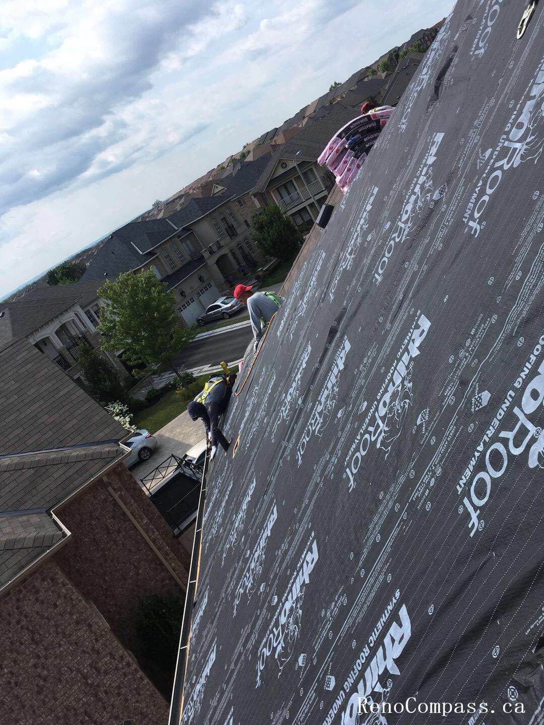 This image highlights a critical stage of a residential roof replacement project in Markham, featuring the installation of a high-performance waterproof roofing membrane over the roof decking. The protective underlayment is carefully applied to enhance moisture resistance, improve insulation support, and provide a durable base for the final shingle installation. Proper alignment and sealing around roof penetrations and edges ensure reliable weather protection against Markham’s changing climate conditions. Completed by a professional renovation and roofing team, this roof preparation process strengthens structural integrity and ensures long-lasting performance for the new roofing system.