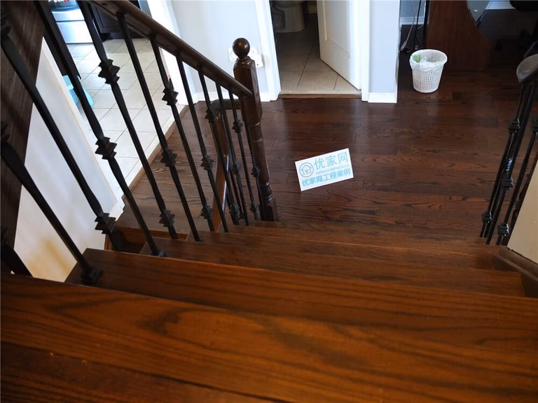 This close-up image showcases the rich natural wood grain of newly installed hardwood flooring in a Mississauga home renovation project. The flooring features deep brown tones, precise plank alignment, and clean baseboard finishes that create a refined and durable interior surface. As a professional Toronto Renovation Company, Reno Compass specializes in high-quality hardwood flooring installation that enhances both aesthetic appeal and long-term value for residential properties.