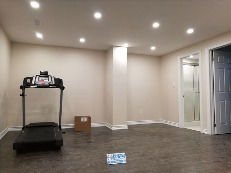 This Aurora basement renovation features a bright and spacious recreation area with recessed pot lights, modern vinyl flooring, and clean neutral wall finishes. The open layout provides a comfortable space for exercise, relaxation, or family activities while improving the functionality of the basement. As a professional Toronto Renovation Company, Reno Compass focuses on creating well-designed interior renovation spaces that enhance comfort, lighting, and everyday usability for homeowners across the GTA.
