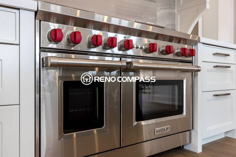 This Newmarket kitchen renovation features a high-end stainless steel gas range with signature red control knobs, designed for professional cooking performance. The appliance is seamlessly integrated with custom cabinetry, quartz countertops, and engineered wood flooring to create a modern and functional kitchen space. Completed by a trusted Toronto renovation company, Reno Compass Inc., this project highlights premium materials and refined craftsmanship.