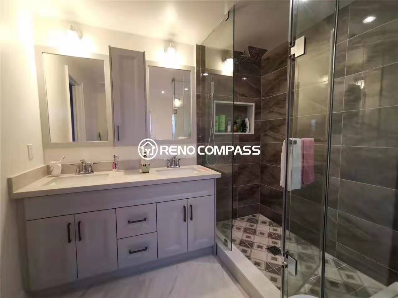 This Markham bathroom renovation showcases a spacious double vanity, custom cabinetry, and a sleek glass-enclosed walk-in shower designed for modern family living. The upgraded layout improves functionality while enhancing brightness with updated lighting and mirrors. Completed by a professional Toronto renovation company, the bathroom features durable flooring, contemporary fixtures, and a clean neutral palette that balances style with everyday practicality for homeowners seeking quality bathroom renovation in Markham.