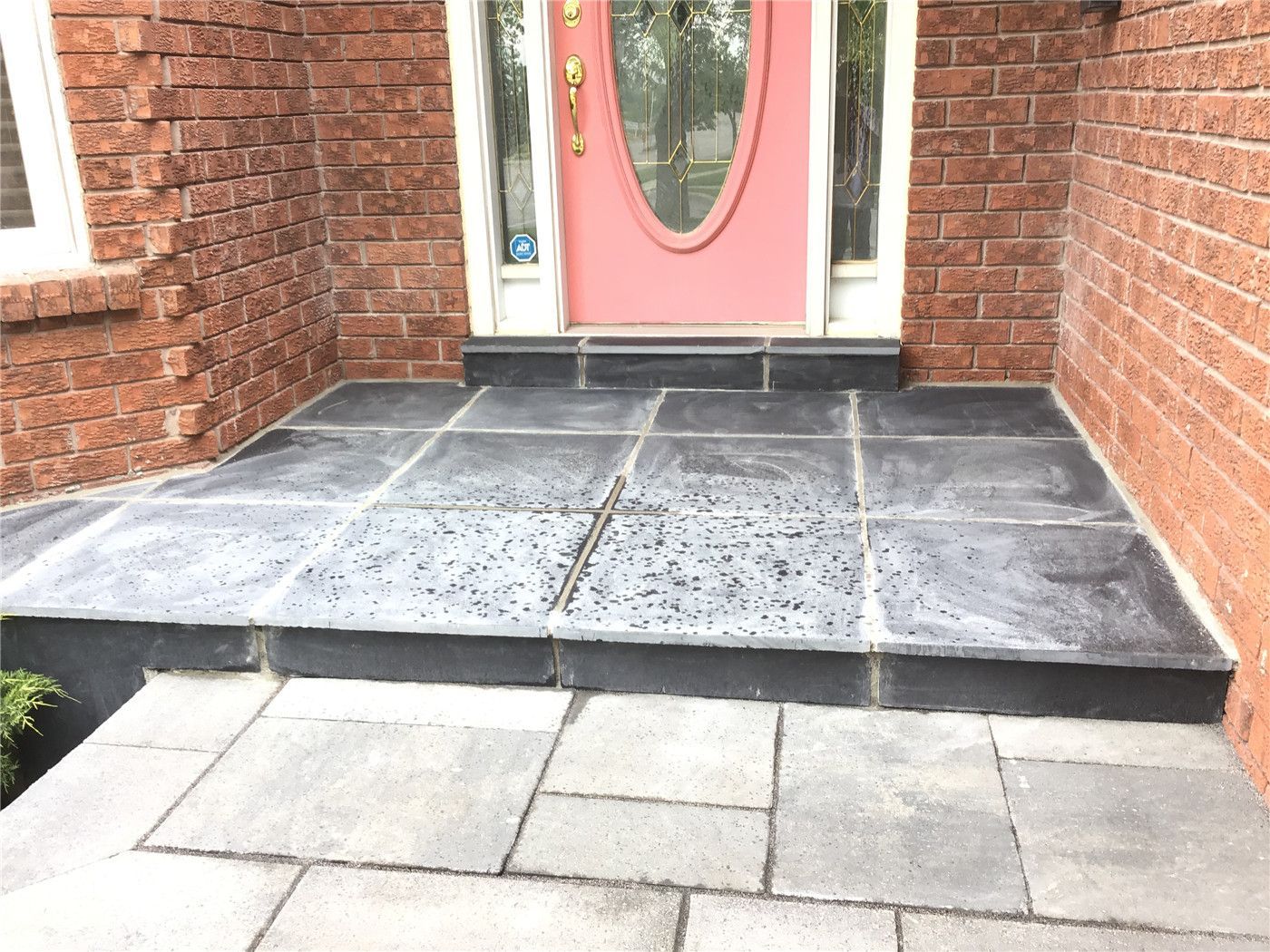 This Mississauga landscaping renovation features a professionally installed interlocking driveway with a modern grey tone and clean border design. The project enhances curb appeal while ensuring durability, proper drainage, and long-term low maintenance.