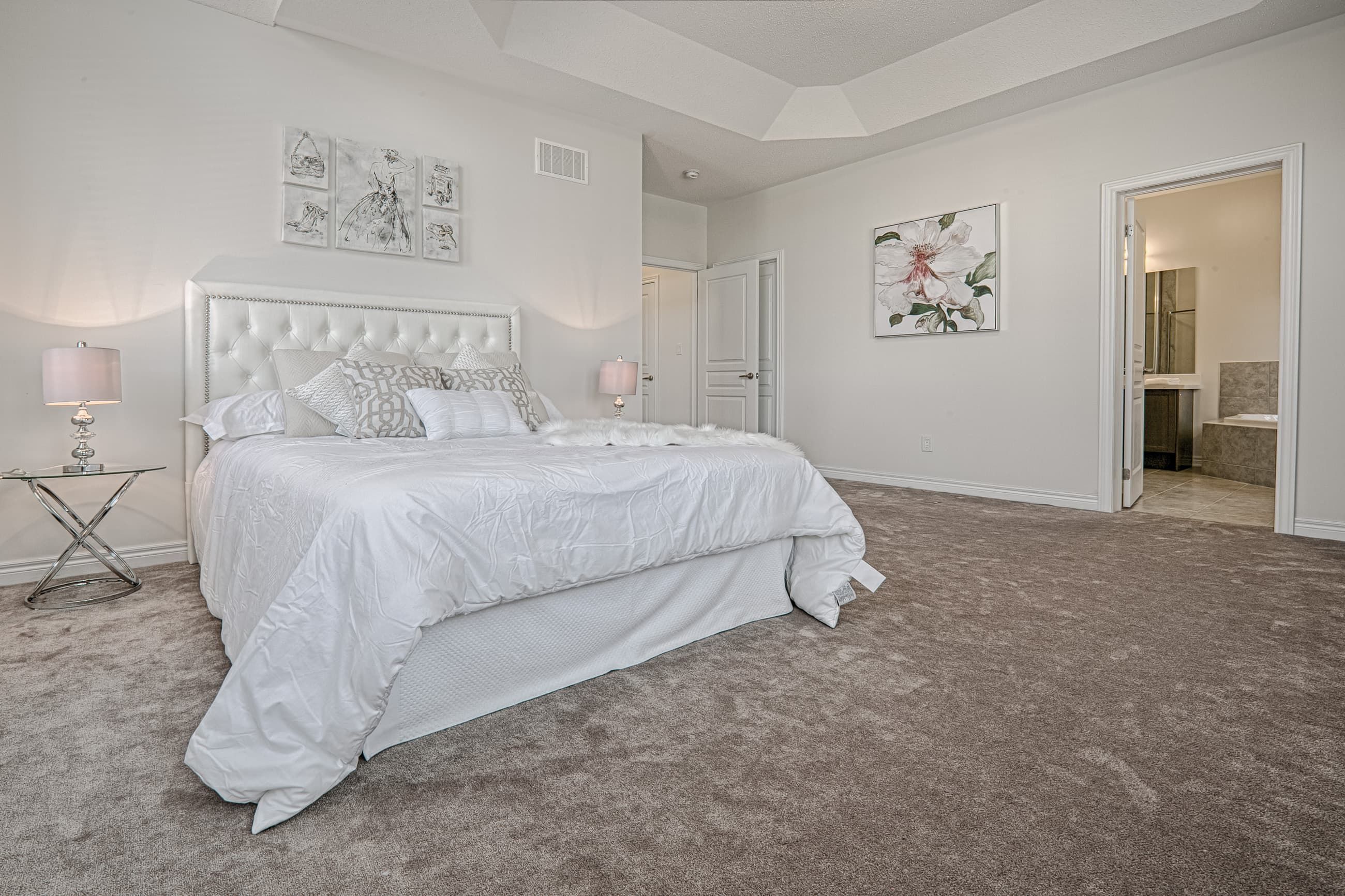 This Toronto luxury master bedroom renovation features a spacious layout with high ceilings, large arched windows, and soft neutral finishes that create a bright and relaxing atmosphere. The design includes premium carpeting, elegant lighting fixtures, and a functional layout that enhances comfort and everyday living. Completed by a professional Toronto renovation company, this bedroom interior project showcases quality craftsmanship, modern design, and timeless residential elegance tailored for contemporary homes.