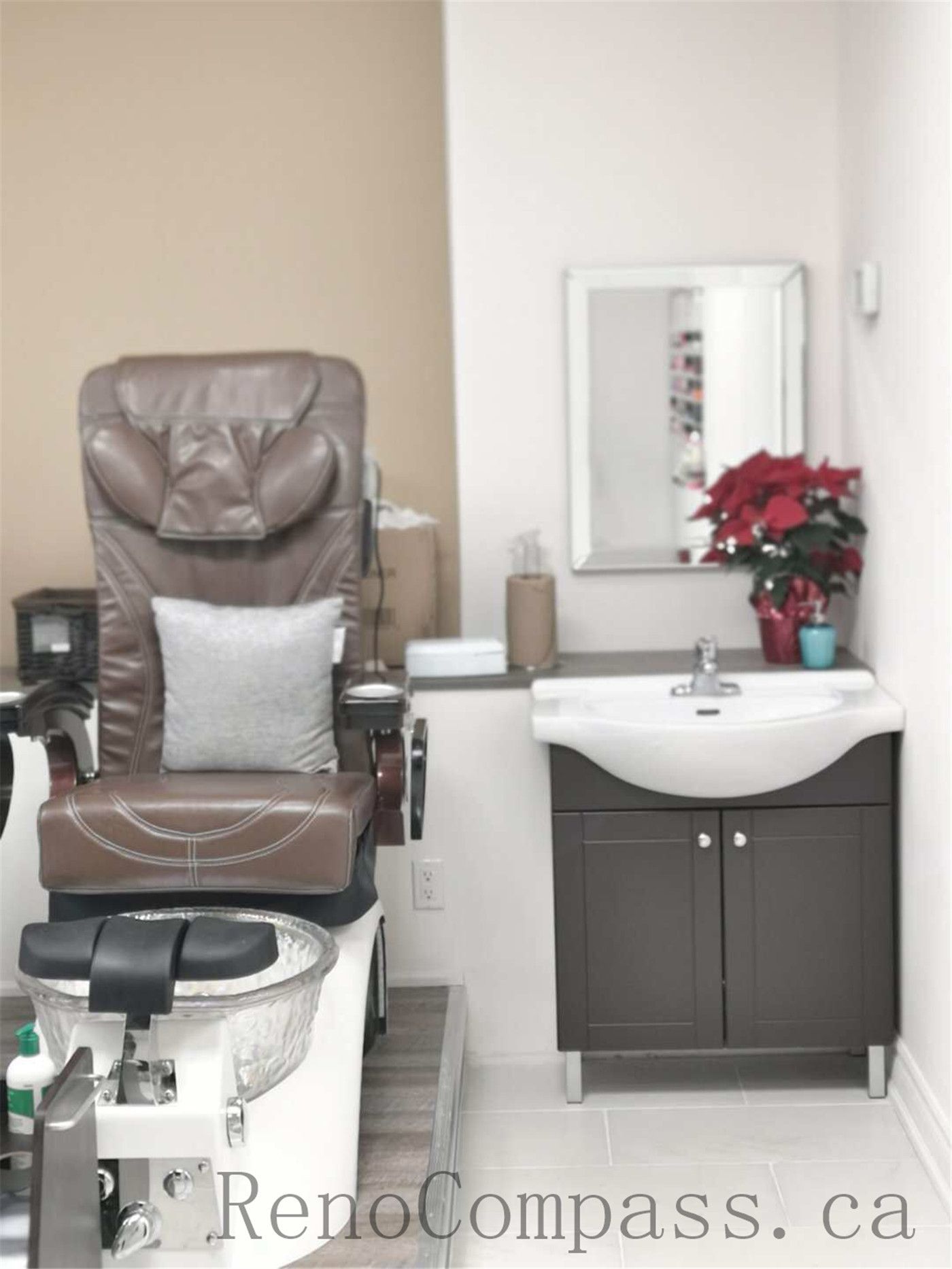 Toronto nail spa commercial renovation featuring a clean and welcoming reception counter, modern cabinetry, and a bright pedicure area with ergonomic client seating and integrated spa basins. The upgraded salon interior emphasizes hygiene, comfort, and efficient layout planning to enhance daily operations. Commercial beauty salon renovation completed by Reno Compass Inc., a professional Toronto renovation company specializing in nail spa and retail spaces.