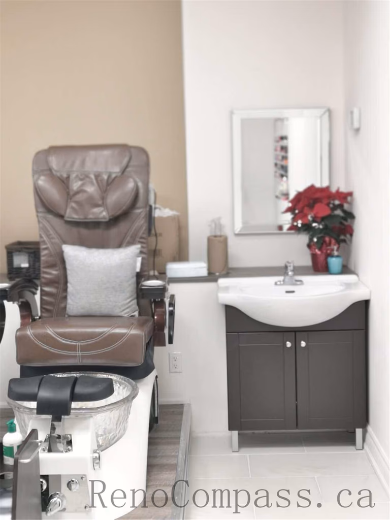 Toronto nail spa commercial renovation featuring a clean and welcoming reception counter, modern cabinetry, and a bright pedicure area with ergonomic client seating and integrated spa basins. The upgraded salon interior emphasizes hygiene, comfort, and efficient layout planning to enhance daily operations. Commercial beauty salon renovation completed by Reno Compass Inc., a professional Toronto renovation company specializing in nail spa and retail spaces.