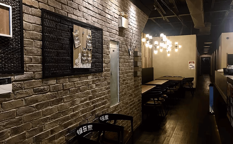 This Toronto commercial interior design project highlights a stylish restaurant and lounge space featuring exposed brick walls, warm ambient lighting, and modern industrial details. The design blends rustic textures with contemporary furnishings, creating a welcoming yet sophisticated dining environment. Custom wall décor, designer lighting fixtures, and streamlined seating arrangements enhance both visual appeal and functionality.

Completed by a professional Toronto commercial renovation and interior design team, this space demonstrates thoughtful layout planning and cohesive material selection, making it ideal for restaurants, private dining venues, cafés, and entertainment lounges seeking a modern industrial atmosphere.