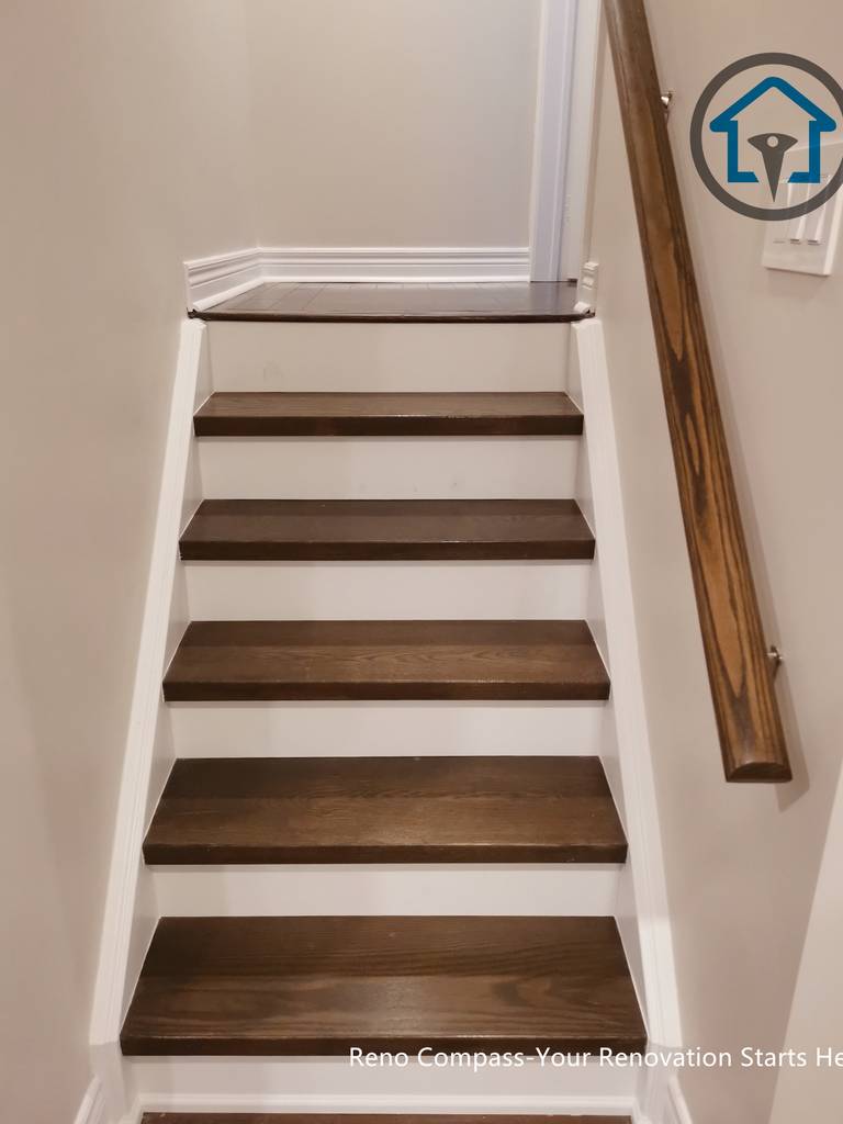Basement staircase renovation in Markham with modern wood stair finishes, clean lines, and integrated design connecting basement and upper living areas.