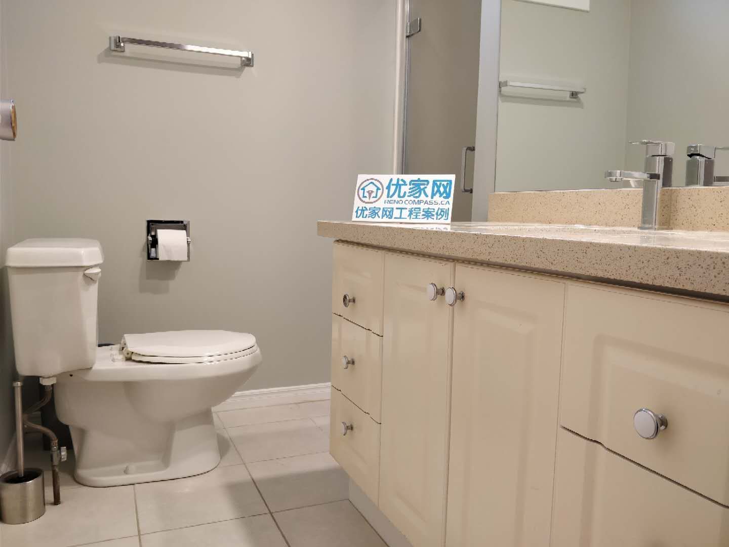 Modern bathroom vanity installed during a Scarborough interior renovation project. The design features a quartz countertop, under-mount sink, sleek chrome faucet, large wall mirror, and custom storage cabinetry, creating a clean and functional bathroom space with a bright and contemporary look.