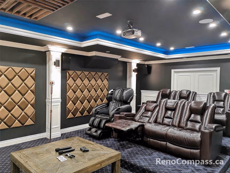 High-end home theatre installation in Mississauga featuring a large projection screen, custom ceiling lighting, built-in speakers, and luxury reclining seating. This professionally designed basement cinema combines acoustic optimization, modern lighting design, and premium finishes to create an immersive private movie theatre experience for homeowners seeking comfort and entertainment.