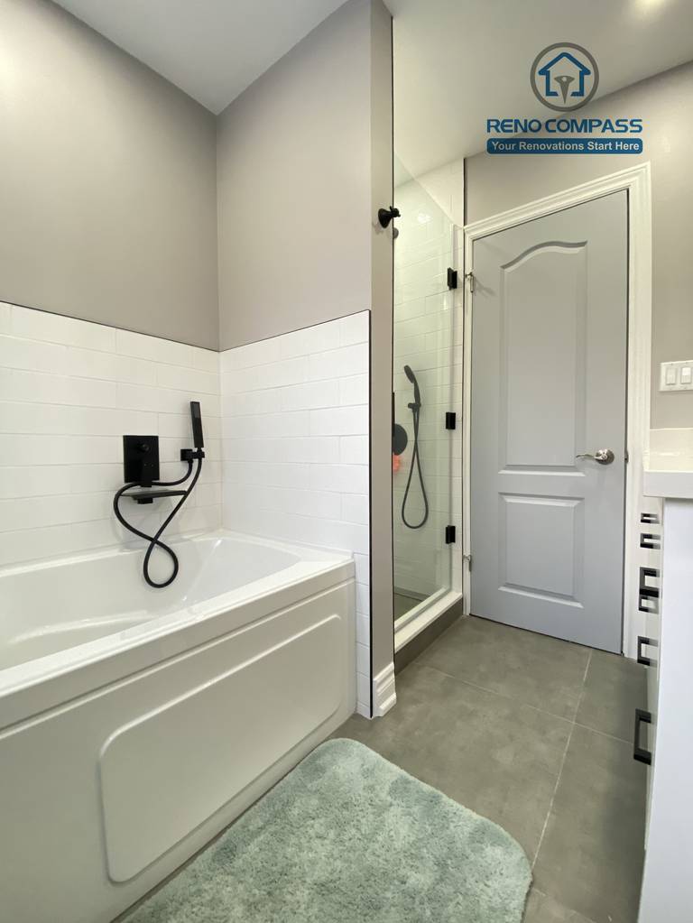 This North York bathroom renovation features a well-balanced bathtub and glass-enclosed shower combination with matte black fixtures and clean white tile walls. The layout maximizes space and functionality while maintaining a bright, modern look, completed by a Toronto renovation company focused on efficient design and long-term performance.