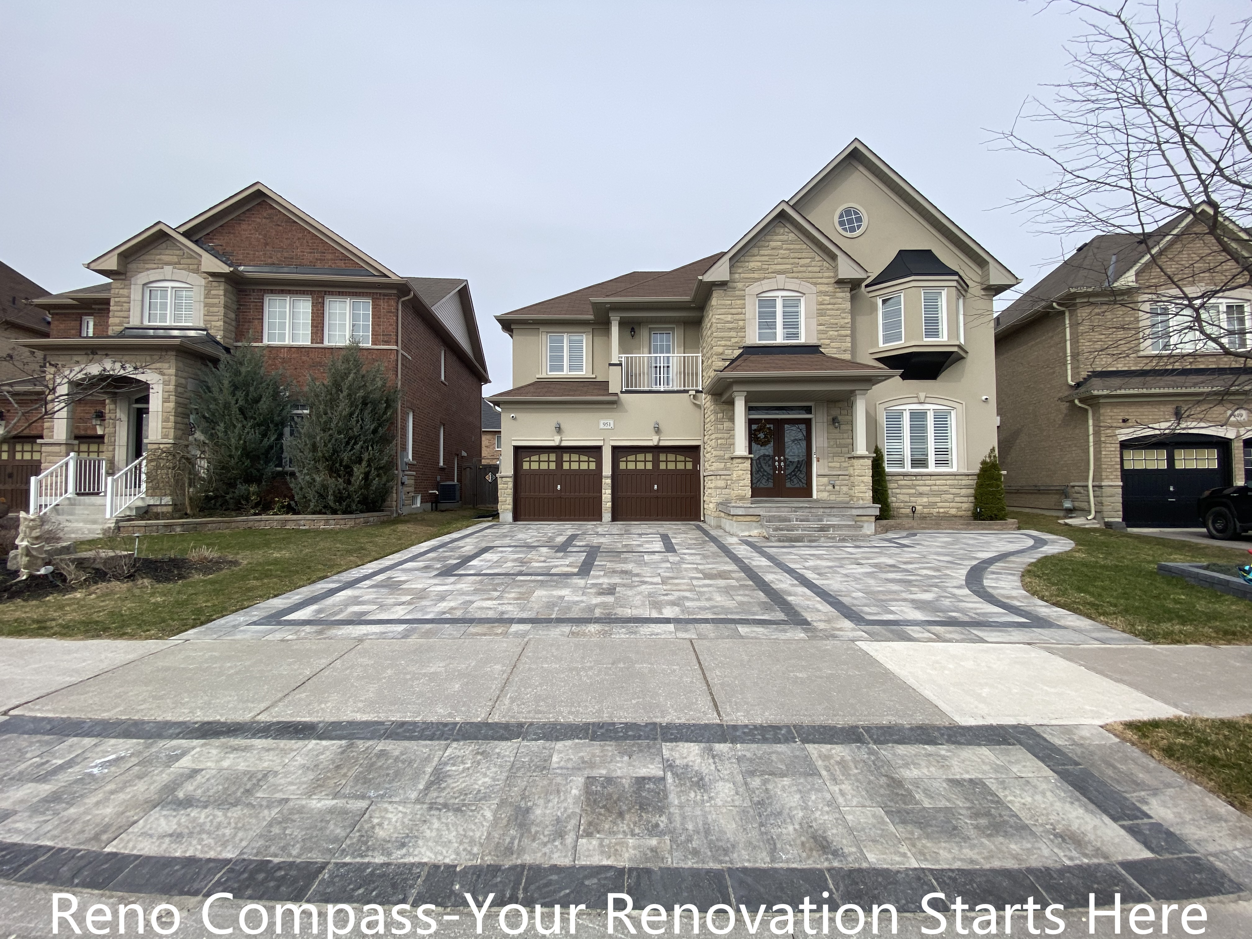 Front yard interlocking driveway renovation in Newmarket featuring large-format concrete pavers with geometric patterns and clean border detailing. The upgraded driveway enhances curb appeal, improves drainage performance, and creates a durable, low-maintenance outdoor surface. Designed and completed by a professional Toronto renovation company with a focus on long-lasting materials and precise installation.