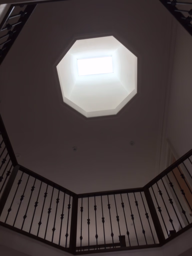 This Toronto interior renovation project highlights a striking octagonal skylight positioned above a multi-level staircase, bringing natural light deep into the home’s interior. The skylight design enhances vertical space, improves daylight distribution, and creates a strong architectural focal point within the stairwell.

Surrounded by elegant iron railings, the open stair layout feels brighter and more spacious, while maintaining safety and visual continuity between floors. The combination of natural light and clean ceiling lines adds a sense of height and openness, elevating the overall interior experience.

Completed by a professional Toronto renovation company, this skylight and stairwell upgrade demonstrates thoughtful architectural planning, quality craftsmanship, and a refined approach to interior design that balances aesthetics with functionality.