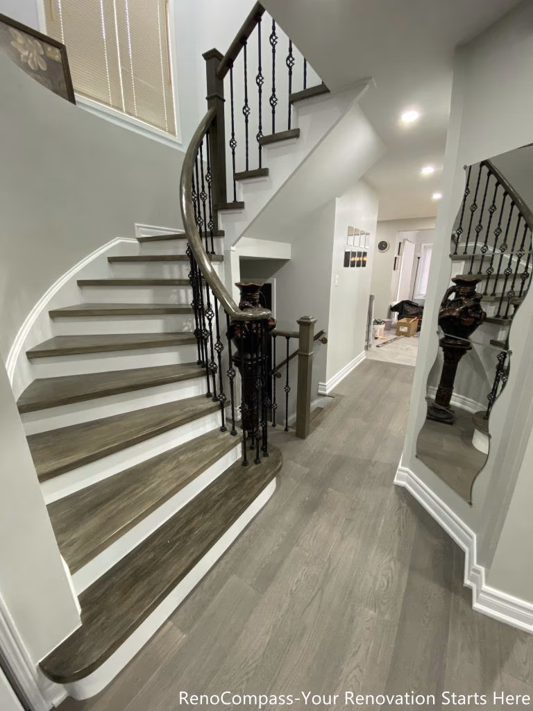 This Mississauga interior renovation features a beautifully upgraded curved staircase with custom wood steps, modern iron railings, and contemporary flooring throughout the main level. The redesign enhances the home’s entrance with improved lighting, clean wall finishes, and seamless transitions between spaces. Completed by a professional Toronto renovation company, this renovation focuses on craftsmanship, durability, and modern aesthetics, creating a bright and elegant interior that increases both functionality and long-term property value.