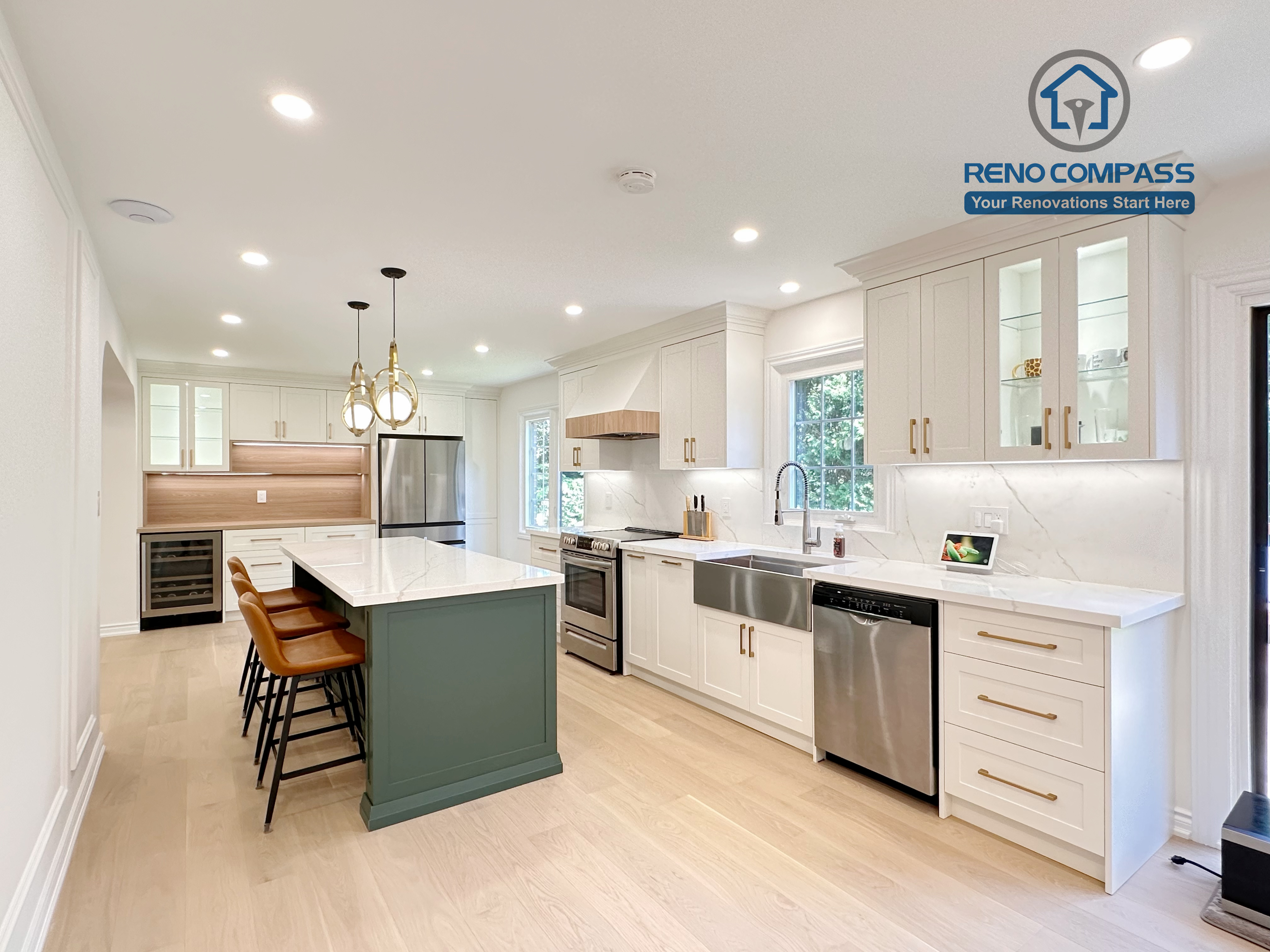 This Markham kitchen renovation features an open-concept layout centered around a custom green island with quartz countertops and seating. White cabinetry, brass hardware, and stainless steel appliances create a clean and cohesive design, while recessed lighting and wide-plank hardwood flooring enhance brightness and flow. Completed by a professional Toronto renovation company, Reno Compass Inc., the kitchen is designed for everyday functionality and long-term comfort.
