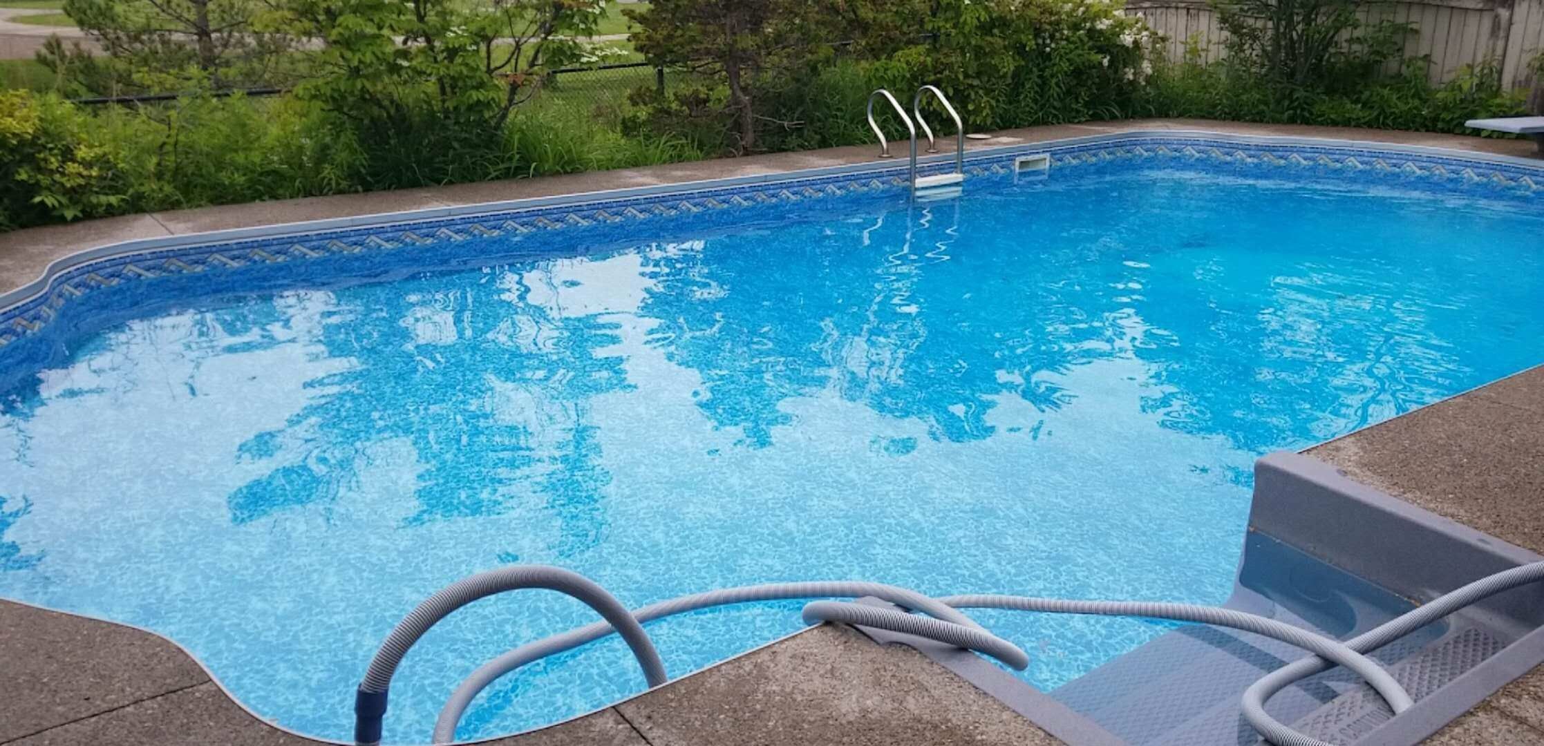 After renovation photo of a fully restored backyard swimming pool in Toronto. The new bright blue liner, clean water, and resurfaced edges highlight the professional pool transformation from old and damaged to modern and inviting. Expert pool renovation by local Toronto specialists.