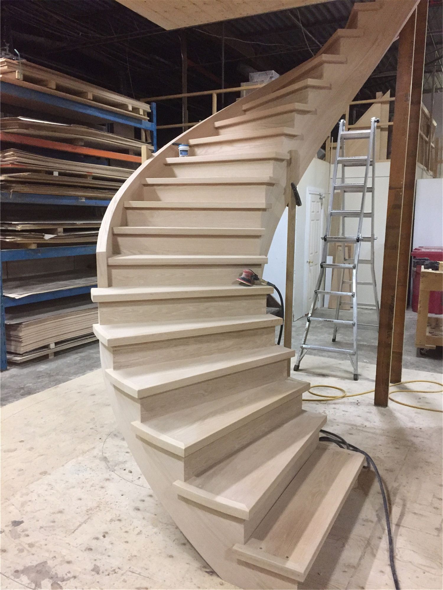 This image captures a custom curved hardwood staircase during the installation phase of a Toronto stair renovation project. The staircase features precisely cut hardwood treads and a smooth sweeping curve that enhances the architectural flow of the interior space. Careful craftsmanship ensures consistent step alignment, structural stability, and a refined appearance. As a professional Toronto Renovation Company, Reno Compass Inc. specializes in custom staircase renovations that combine durability, safety, and elegant design for homes throughout Toronto and the Greater Toronto Area.