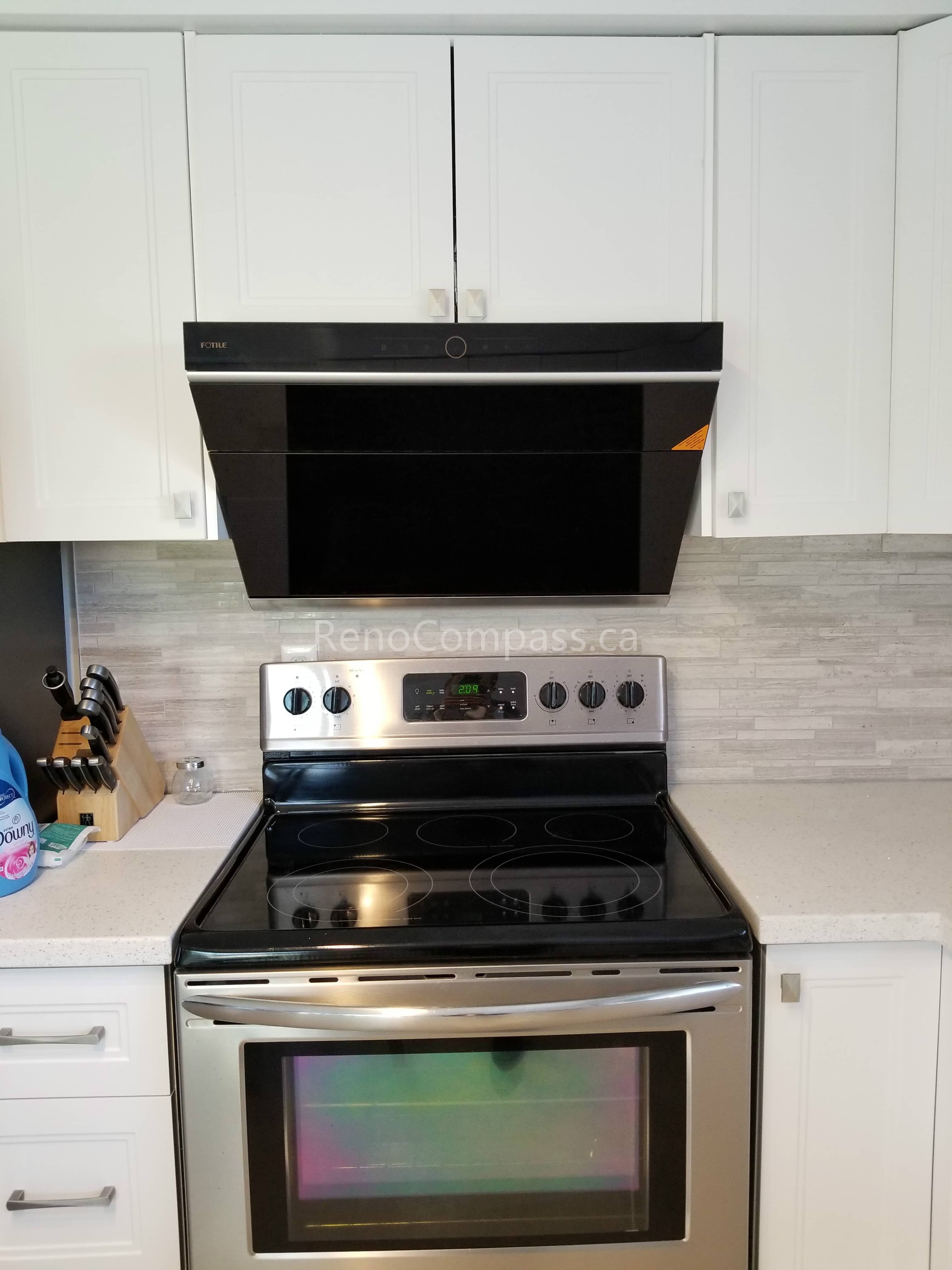 This Mississauga kitchen renovation features clean white cabinetry, modern backsplash tiles, and upgraded stainless steel appliances for a bright and functional cooking space. The sleek range hood and electric stove installation enhance both ventilation and efficiency while maintaining a contemporary aesthetic.

Completed by Reno Compass Inc., this kitchen upgrade combines modern design, practical layout improvements, and quality craftsmanship to create a stylish and comfortable everyday cooking environment.