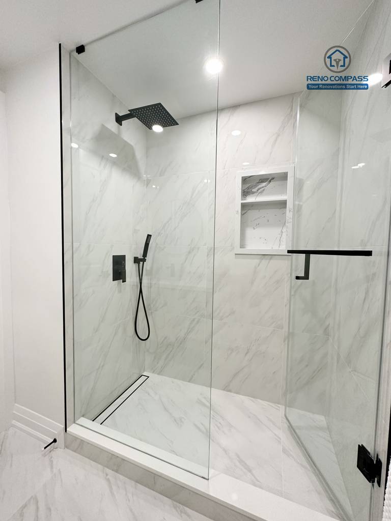 This Richmond Hill interior renovation features a modern bathroom shower with a frameless glass enclosure, marble-look wall tiles, and matte black shower fixtures. The clean, minimal design enhances both functionality and visual elegance. Completed by a Toronto renovation company, the space reflects contemporary bathroom renovation standards and quality craftsmanship.