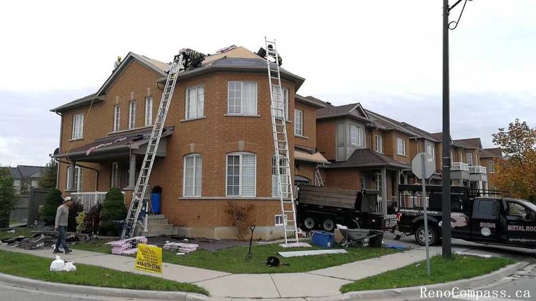 This image shows an active roof replacement project at a residential property in Markham, capturing the full scope of professional roofing work in progress. The project includes complete removal of the existing roofing system, material staging, and preparation for new roof installation. Multiple access ladders, safety setup, and organized debris management reflect a structured and efficient construction process. The roofing upgrade focuses on improving weather resistance, structural protection, and long-term durability while maintaining the home’s original architectural style. Completed by an experienced renovation and roofing team, this Markham roof replacement project enhances both functional performance and overall exterior curb appeal for long-term residential value.