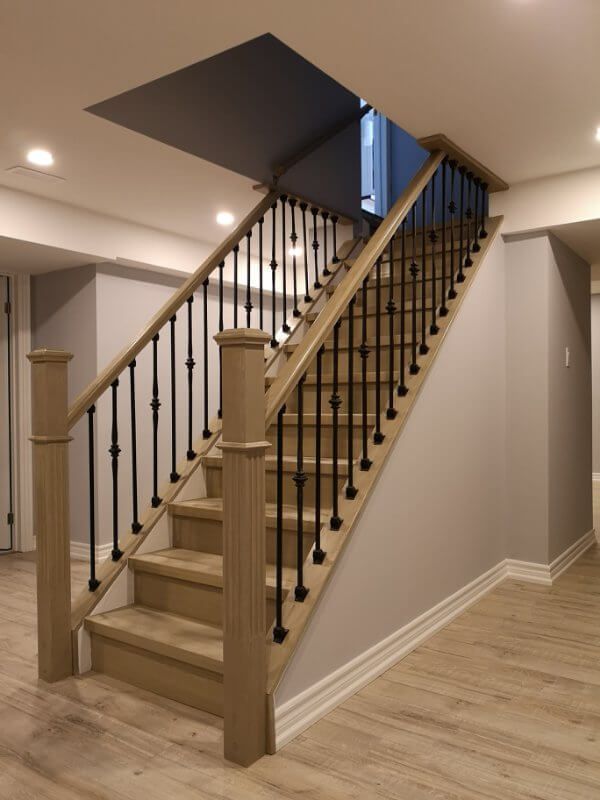 This finished basement renovation in Markham showcases a bright open-concept layout with new flooring, upgraded staircase, modern columns, and recessed lighting. Completed by a trusted Toronto renovation company, the project transforms the basement into a spacious and comfortable living area, enhancing both property value and everyday functionality.