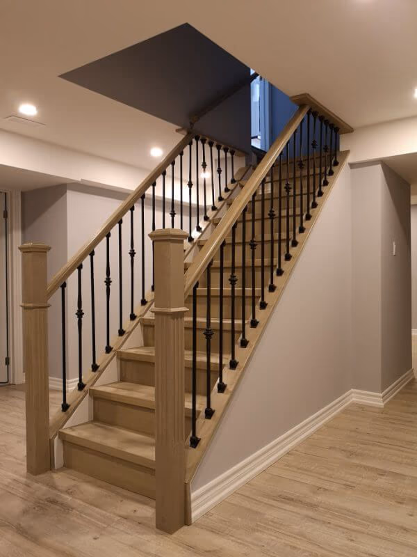 This finished basement renovation in Markham showcases a bright open-concept layout with new flooring, upgraded staircase, modern columns, and recessed lighting. Completed by a trusted Toronto renovation company, the project transforms the basement into a spacious and comfortable living area, enhancing both property value and everyday functionality.