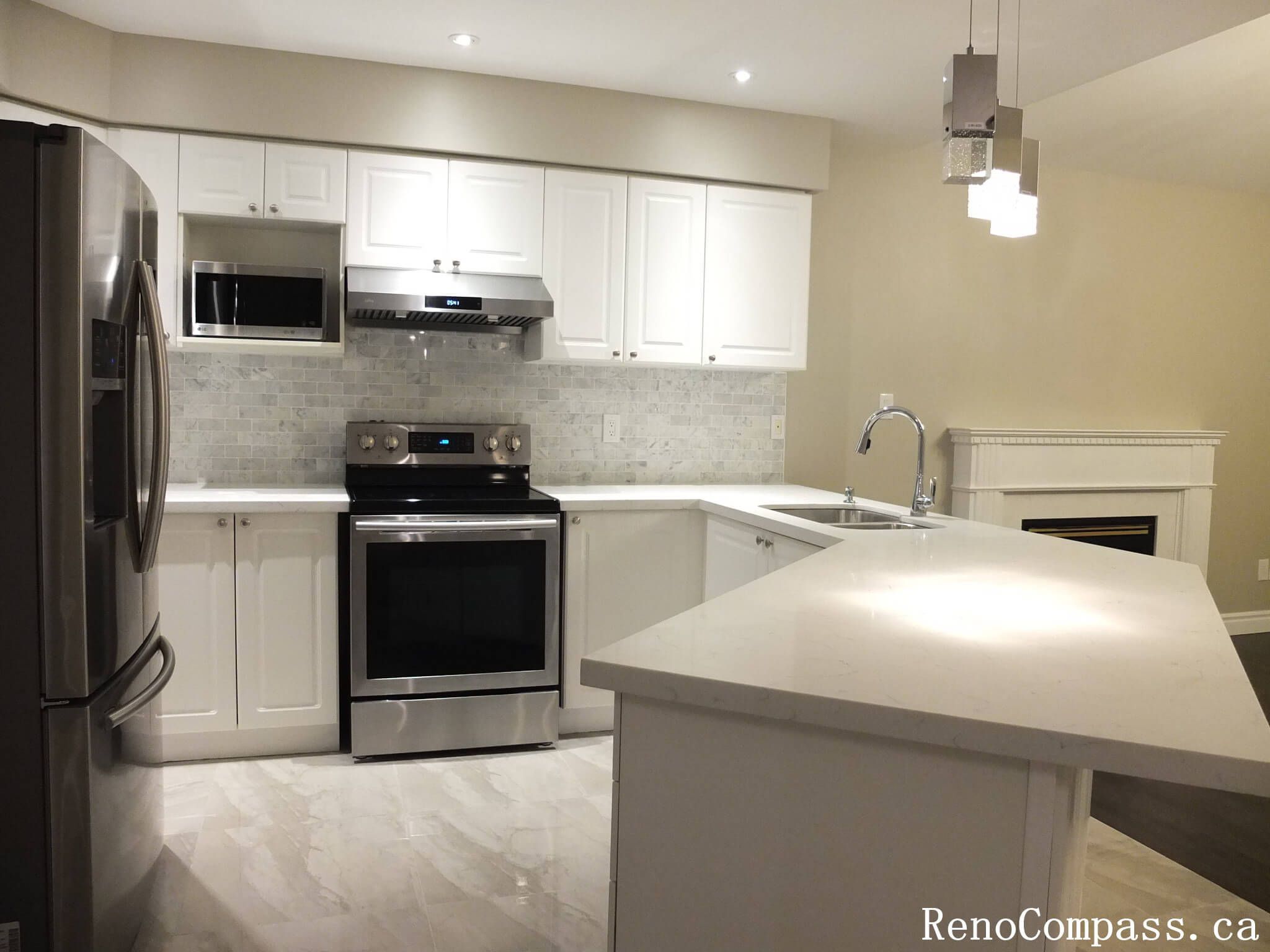 This Richmond Hill kitchen renovation features modern white shaker cabinetry, a spacious quartz island, and stainless steel appliances for a clean and functional layout. Completed by a trusted Toronto renovation company, the design maximizes storage, improves workflow efficiency, and enhances overall brightness. The neutral backsplash and polished finishes create a timeless kitchen space ideal for daily cooking and entertaining.