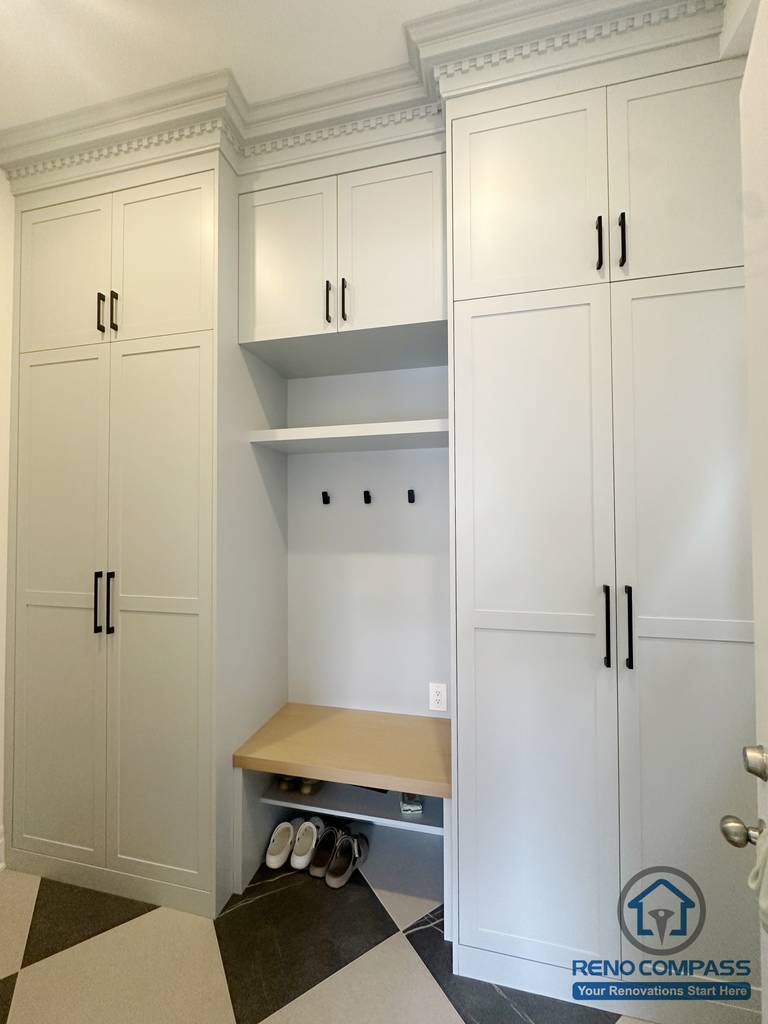 Custom mud room storage in a Toronto new home upgrade, featuring built-in cabinets, a bench, and shoe storage for organized and functional entryway design.