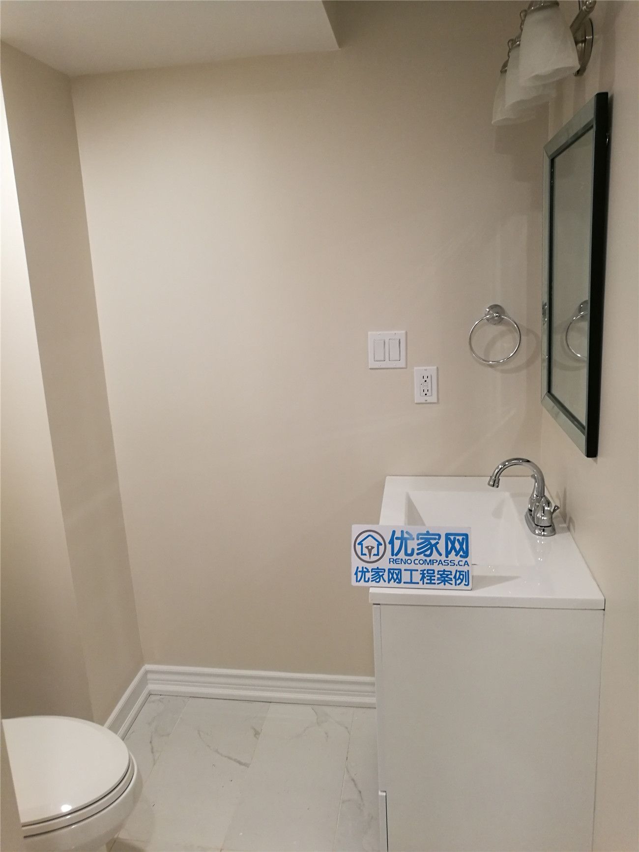This Scarborough basement bathroom renovation features a clean and functional layout with a modern vanity, integrated sink, framed mirror, and updated lighting. Light marble-look flooring and neutral wall tones enhance brightness and create a fresh, spacious feel in a compact basement washroom. Designed for practicality and everyday comfort, the space maximizes usability while maintaining a sleek modern aesthetic. Completed by a professional Toronto renovation company, this project showcases quality workmanship and thoughtful basement bathroom design.