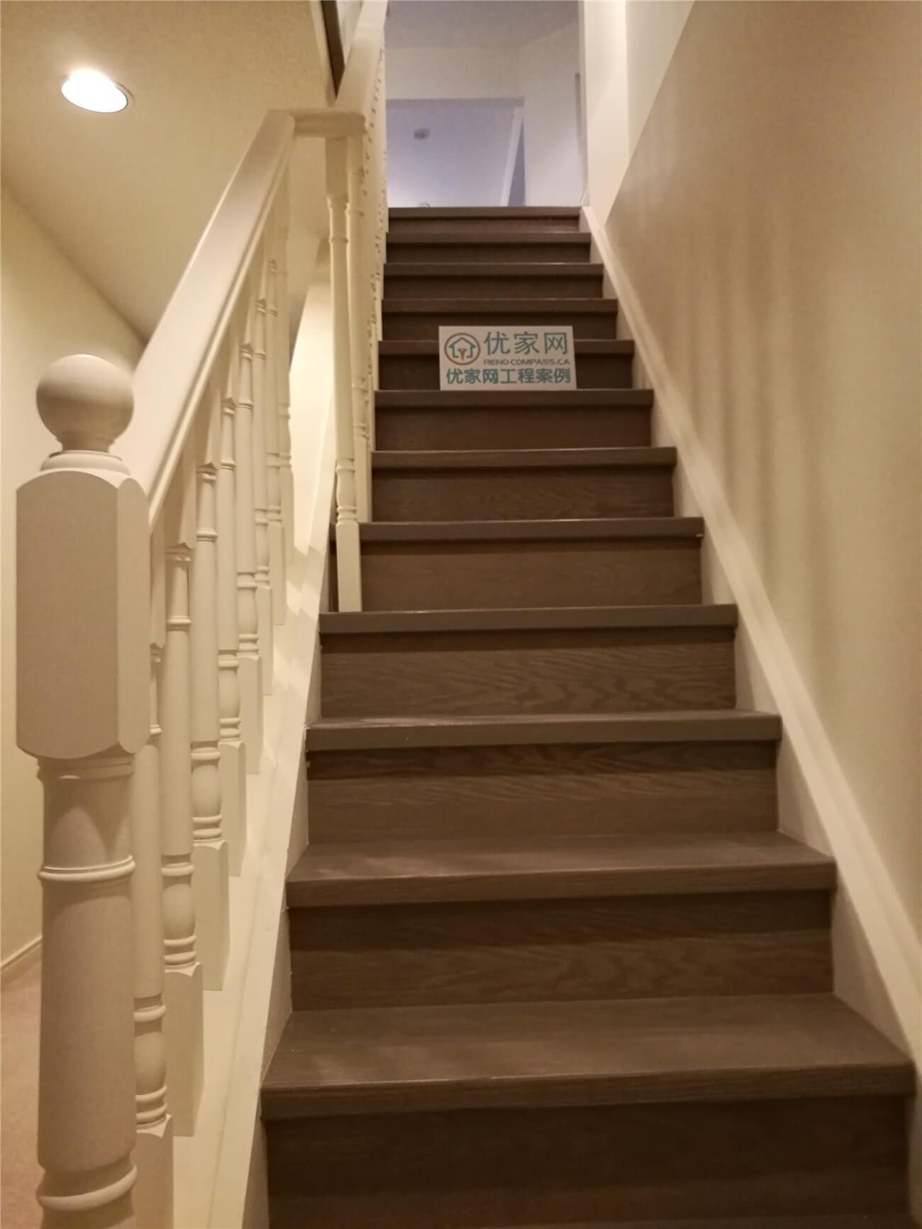 This image highlights a completed staircase flooring renovation in North York, featuring hardwood stair treads paired with classic white railings and balusters. The dark wood finish on the stairs creates strong visual contrast while maintaining a warm and timeless interior aesthetic. Precise stair installation improves safety, durability, and overall visual continuity between levels. This North York flooring renovation demonstrates skilled craftsmanship and careful detailing, delivered by a professional Toronto renovation company specializing in flooring and staircase upgrades.
