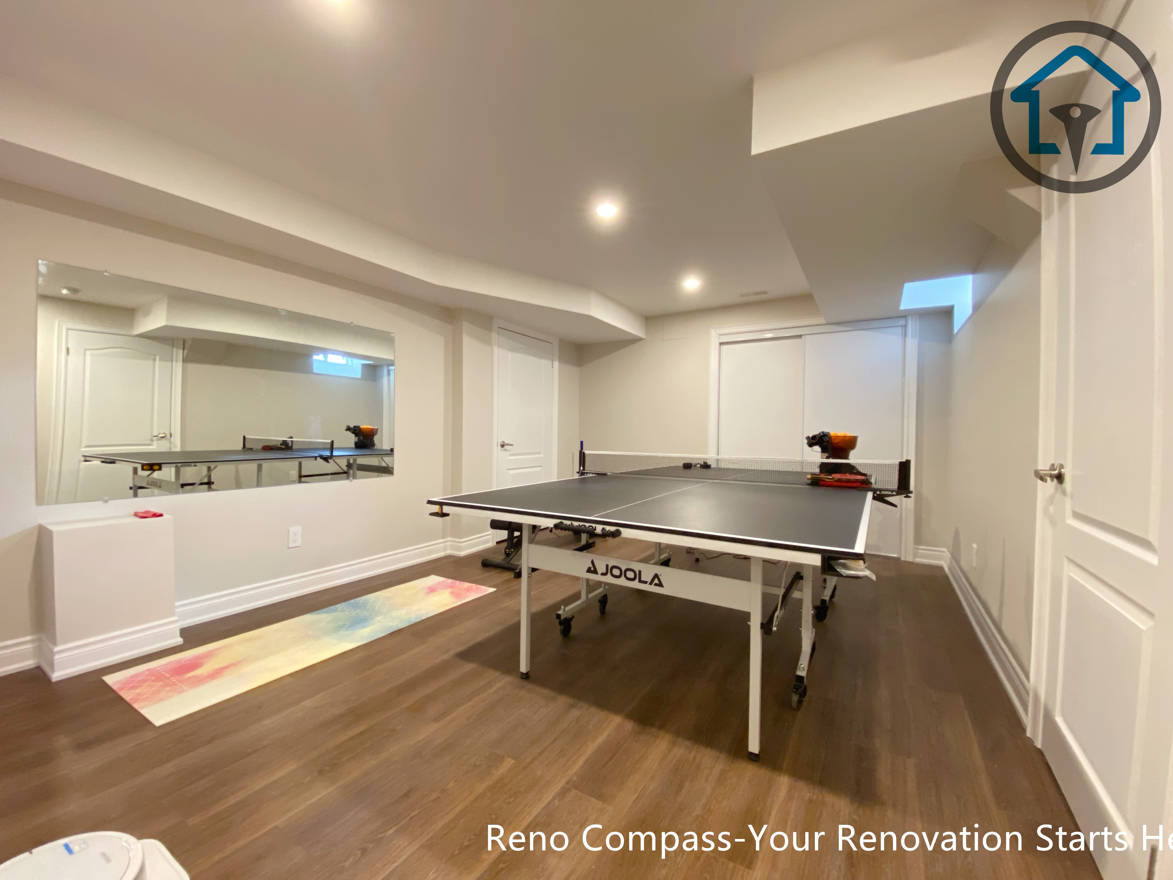 Basement renovation in Markham featuring an open-concept gym and activity area with wood finishes, neutral tones, and flexible space planning for everyday use.