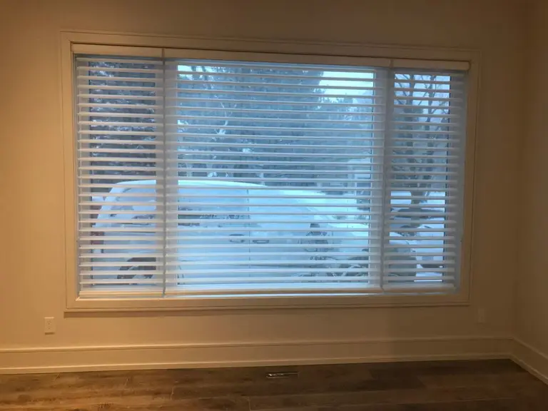 Custom zebra blinds installation in Toronto dining room by professional Toronto renovation company Reno Compass Inc. Featuring dual-layer light filtering shades, clean white window trim, modern chandelier lighting, and elegant wall panel detailing. This window treatment upgrade enhances privacy, natural light control, and interior aesthetics with a sleek and contemporary finish.