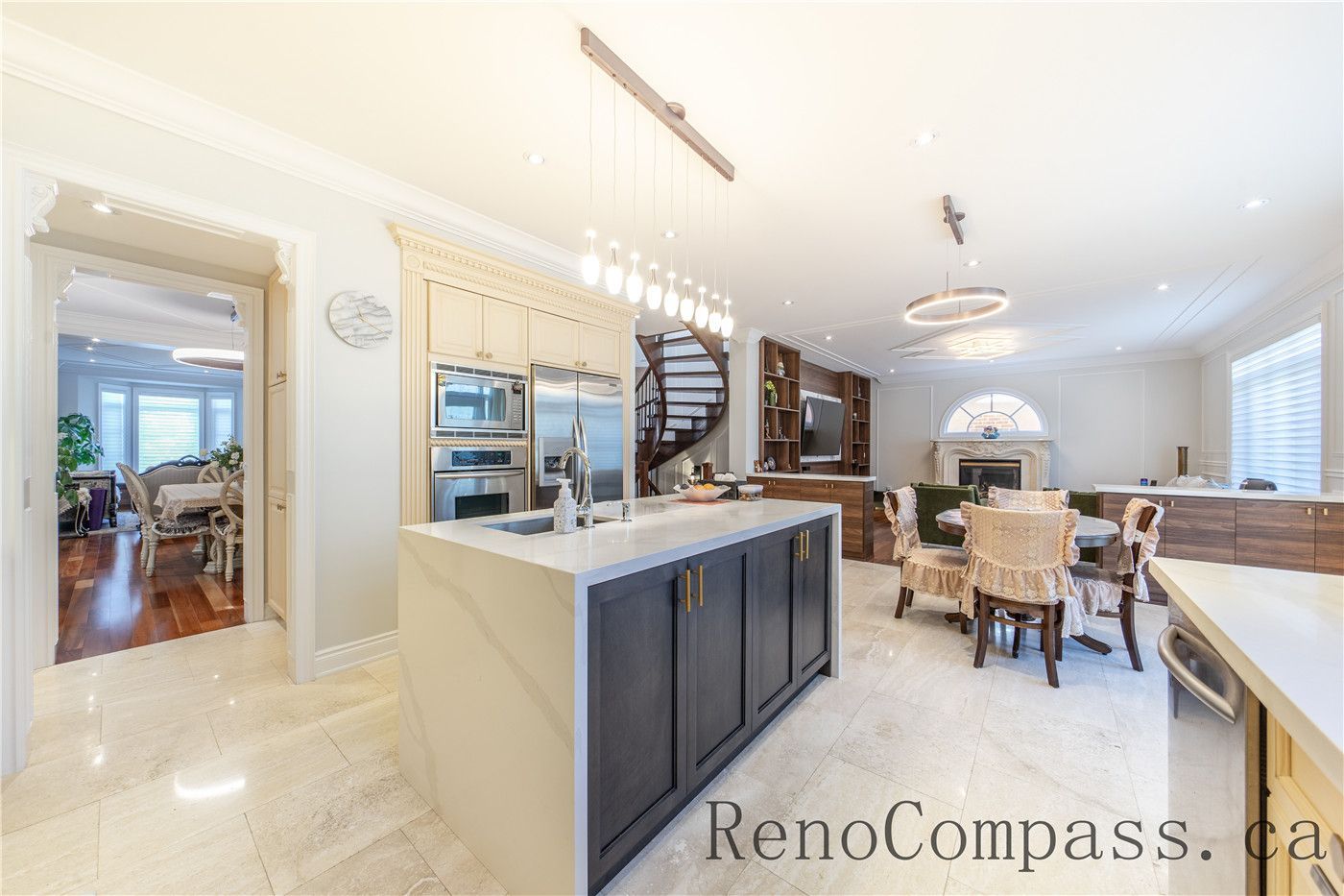 This Richmond Hill entire house interior renovation features a spacious luxury kitchen with a large central island, quartz countertops, and custom cabinetry. Modern pendant lighting and built-in appliances enhance both functionality and style, while the open-concept layout connects seamlessly to the living area. Designed for daily living and entertaining, this bright and elegant kitchen renovation was completed by a professional Toronto renovation company focused on craftsmanship, efficiency, and timeless design.