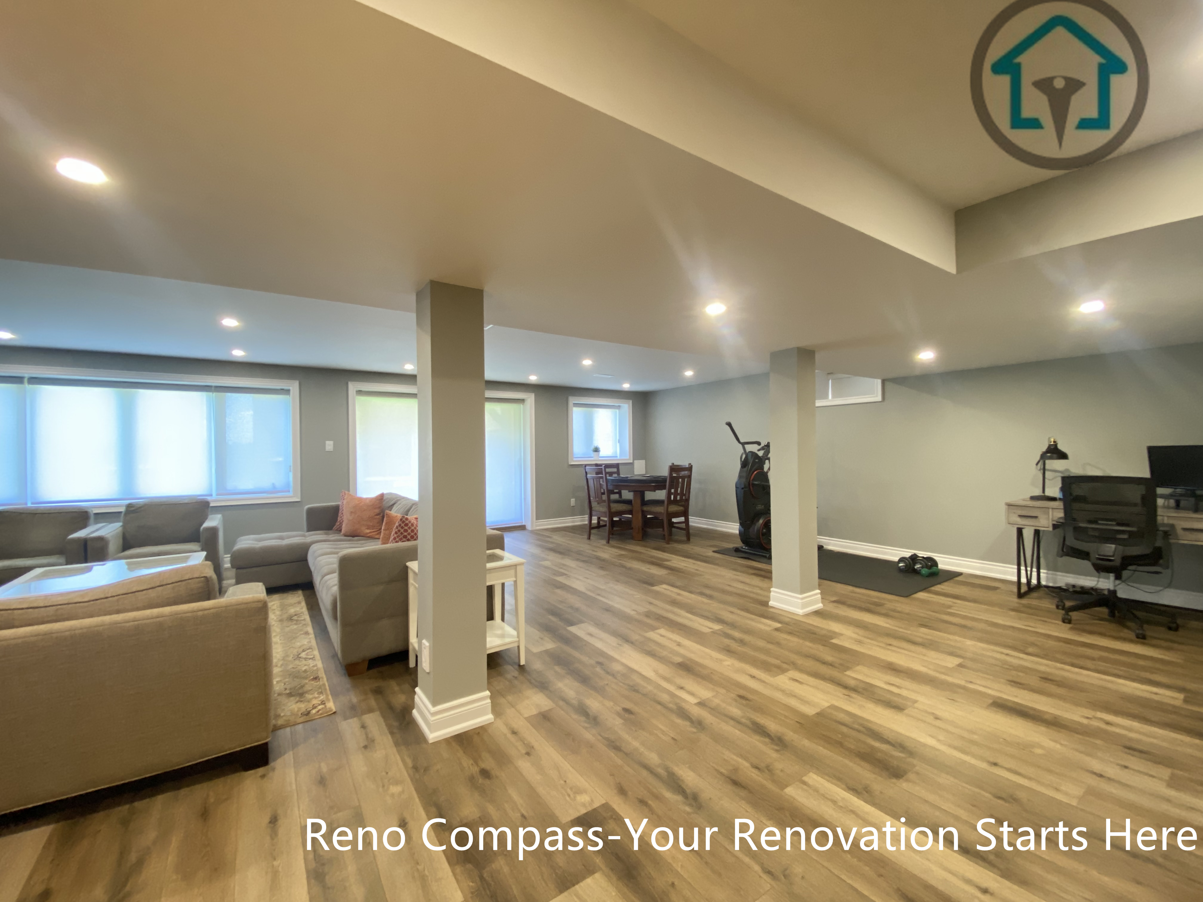An open-concept basement living area completed as part of a Vaughan basement renovation. This finished basement features recessed ceiling lighting, integrated structural columns, durable wood-look flooring, and a spacious layout designed for family gatherings, entertainment, and everyday relaxation.